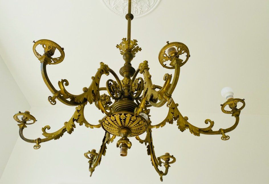 A gaslight chandelier, circa mid-1800s, wired to accommodate modern electric bulbs. Light fixture donated by the Architectural Heritage Center. Photo by Holly Cullom.