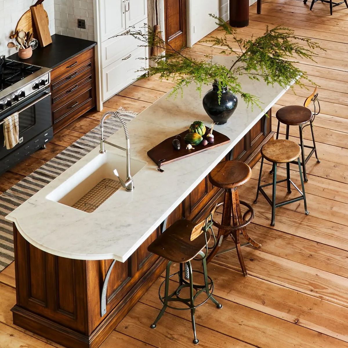 In this vintage-inspired coastal cottage, the island is truly the heart of the home -  a place to cook, gather, and converse in the open kitchen/dining/living space. 