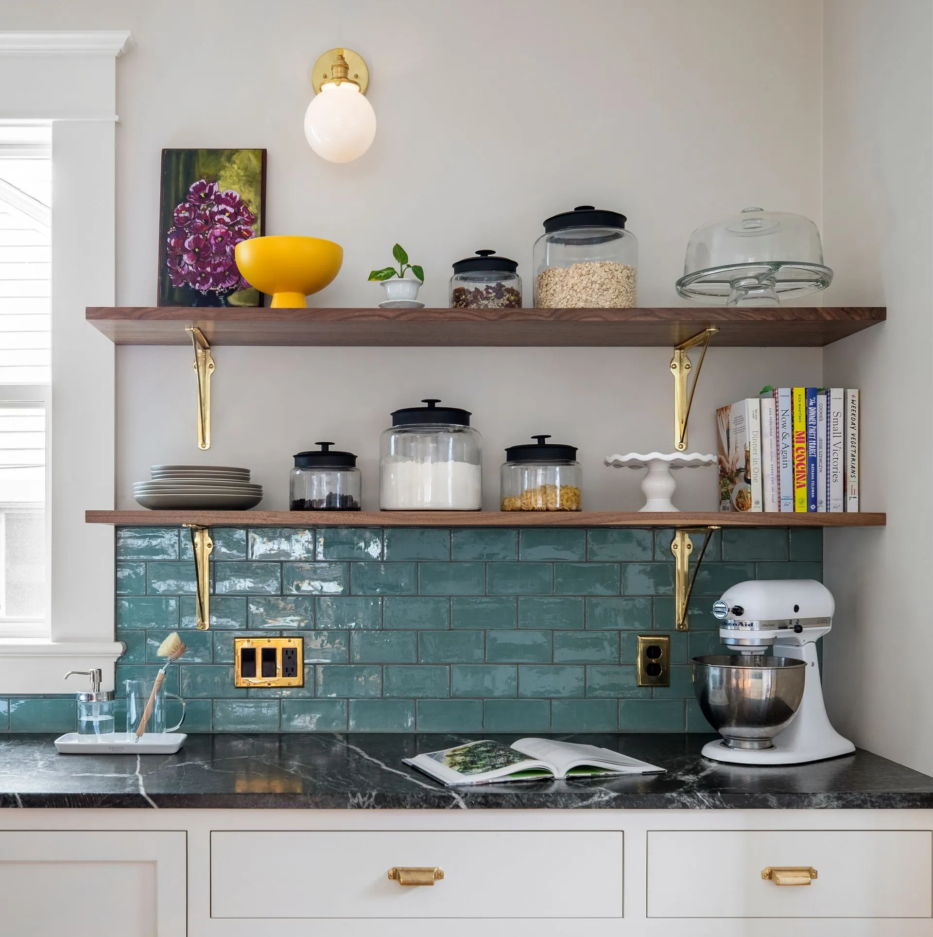 For a Laurelhurst Craftsman home Arciform opted for walnut shelves with brass brackets to keep the space feeling bright and open.  