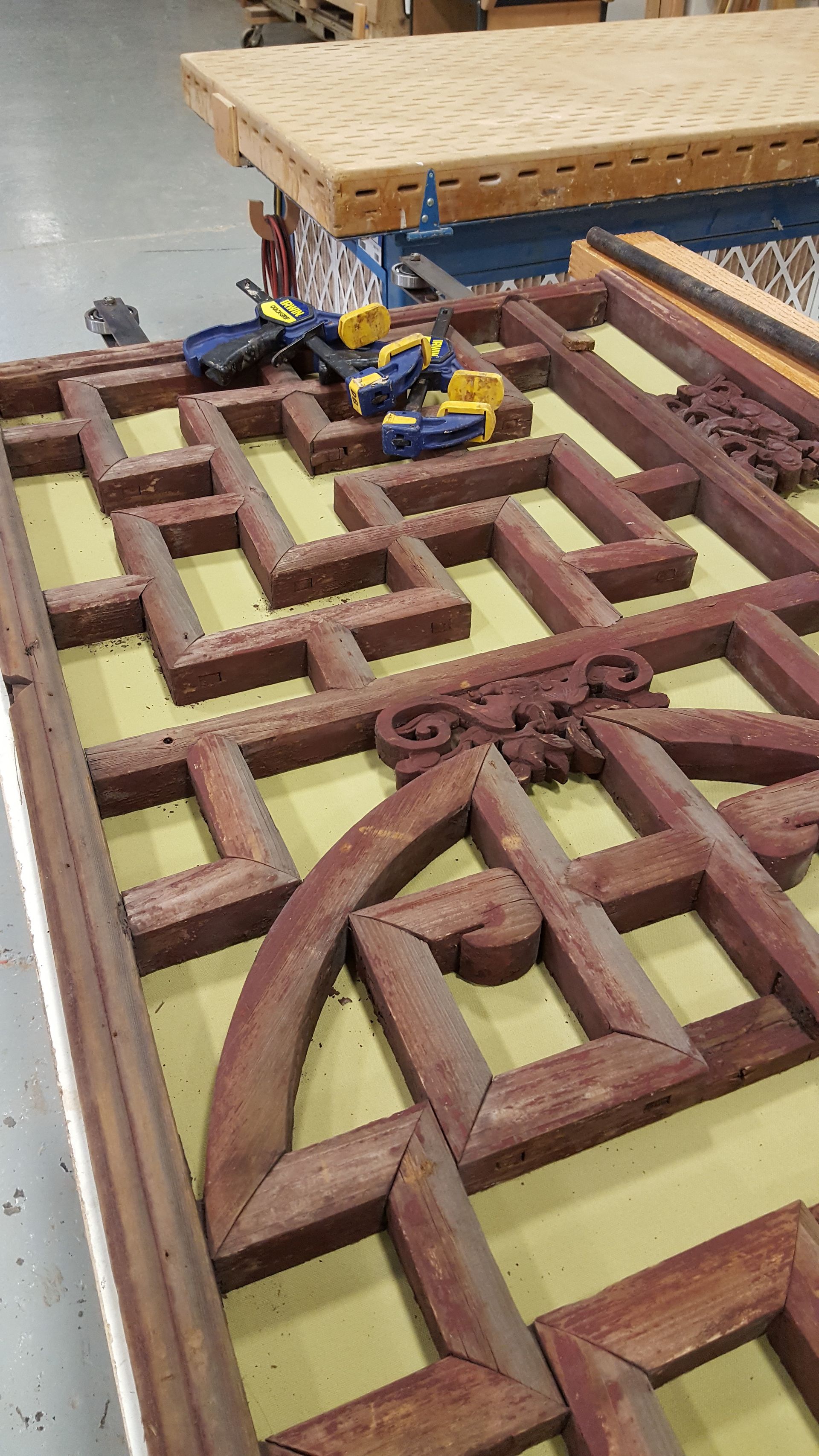 A wooden maze is sitting on top of a wooden table.