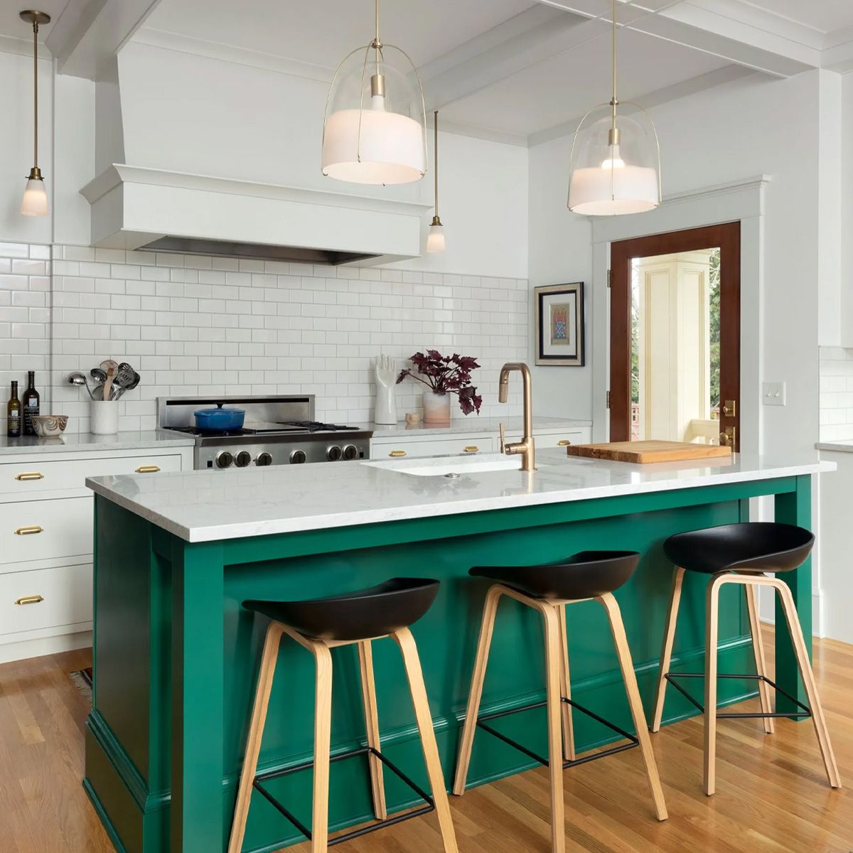 The generously-sized island in this Irvington kitchen adds a punch of bright color to this otherwise all-white space.
