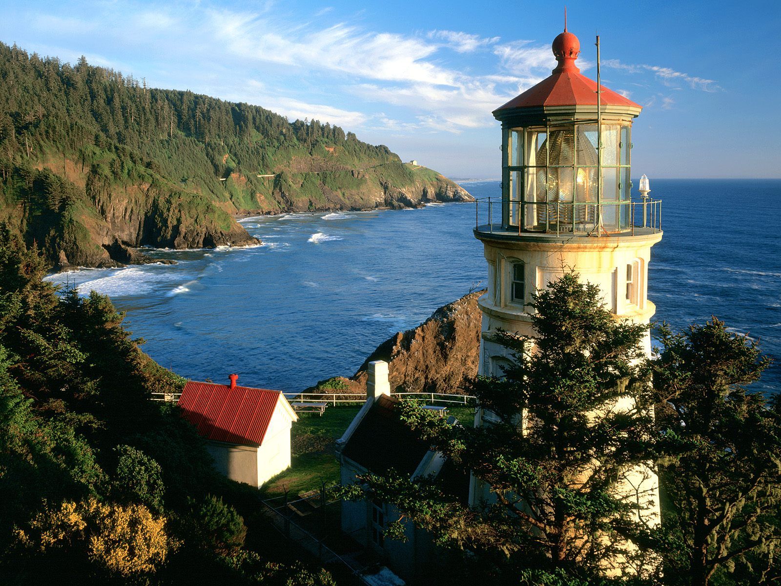 A lighthouse on a cliff overlooking the ocean