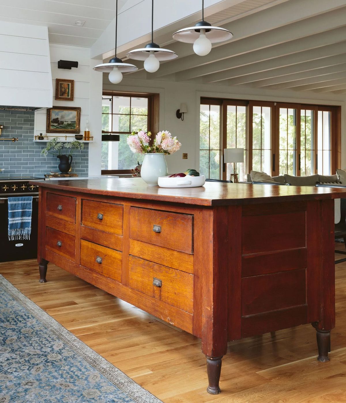 In Emily Henderson's Portland farmhouse a huge antique store cabinet was repurposed and refurbished as a focal point island separating the open living and kitchen spaces. 