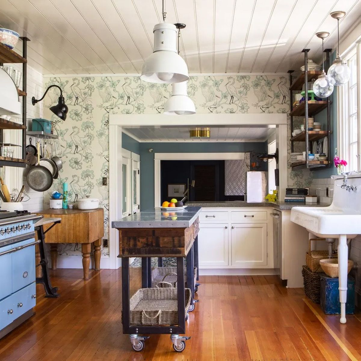 For a 1909 bungalow Arciform designed a vintage-style kitchen with free-standing appliances. A pair of rolling carts with drawers and open shelves below provide flexible workspace. 