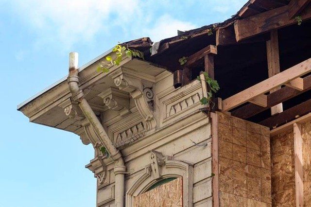 A building with a broken roof is being remodeled.