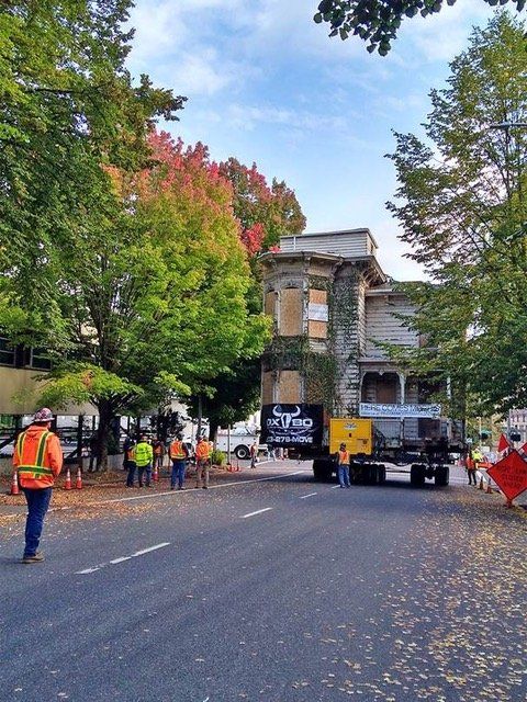 A jeep truck is parked in front of a large building