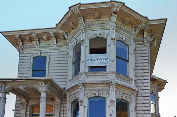An old wooden house with a sign that says open on it