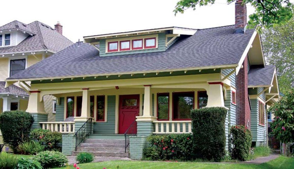 A green and white house with a red door