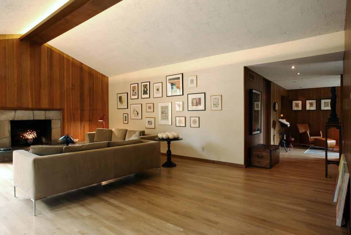 Looking at the living room with its soaring ceiling and restored paneling.