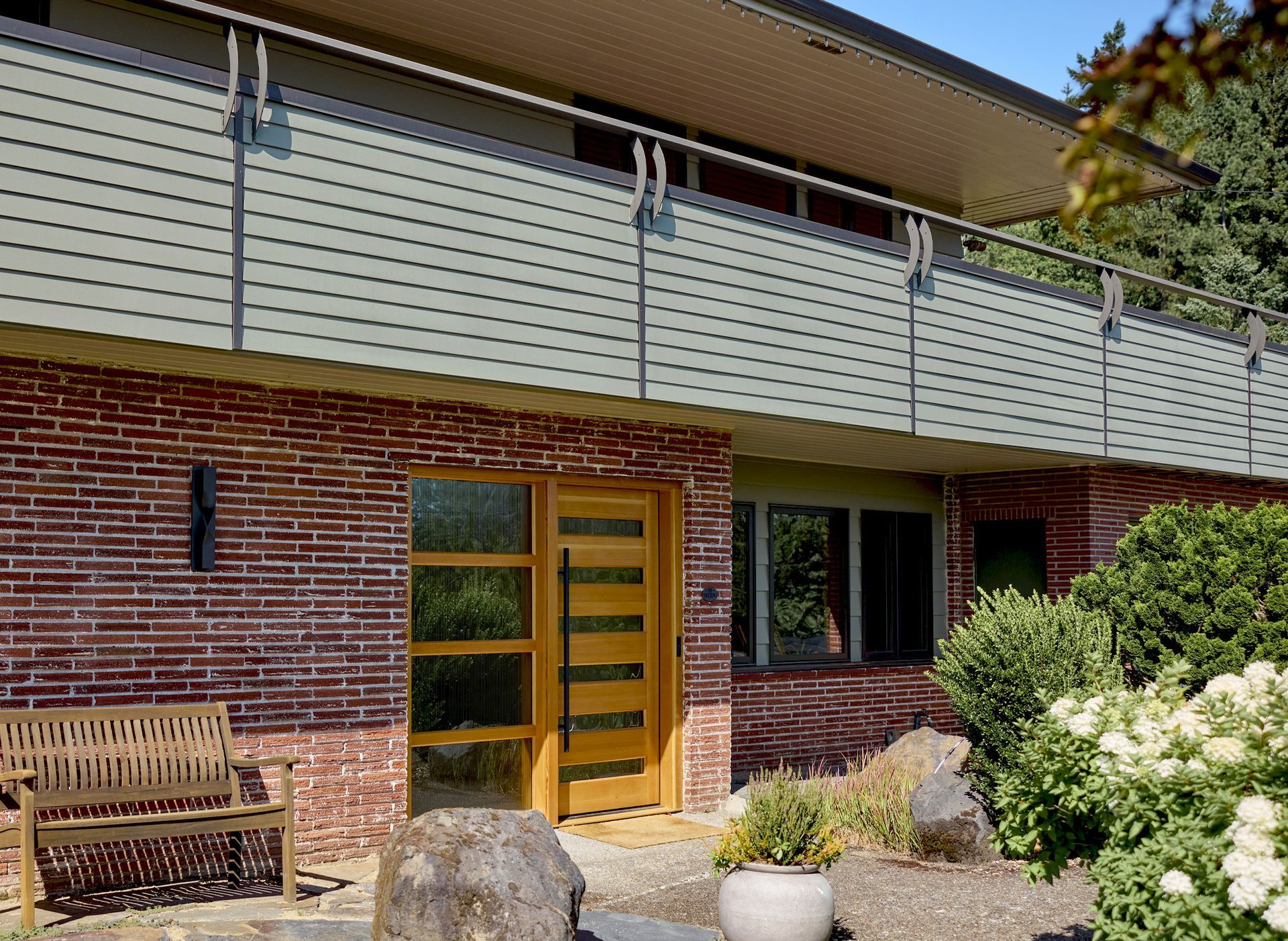Exterior view of the new front door system with the balcony above