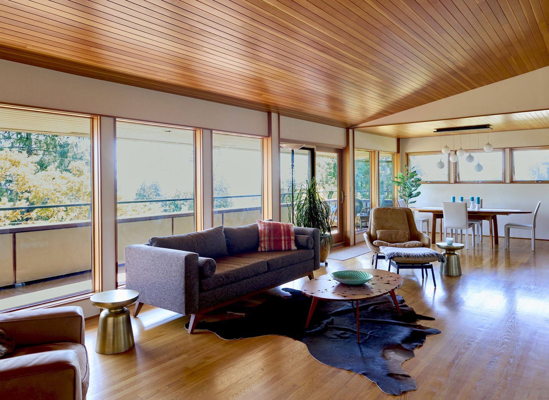 Along the wall of windows is a soft, clean-lined sofa for taking in sunsets and enjoying the fireplace.