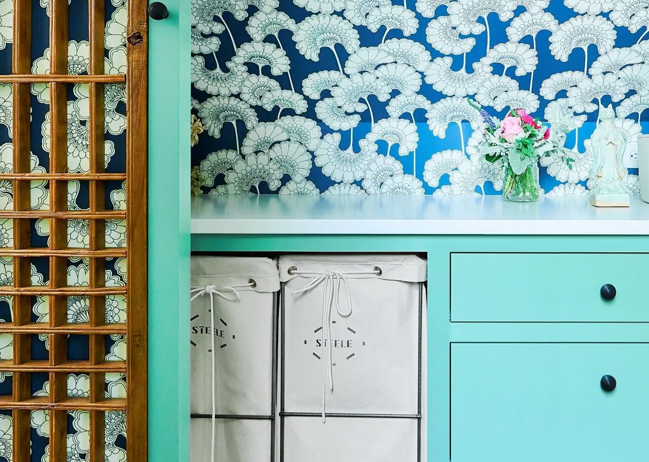 The back of this laundry space tucked under the eaves is papered in Florence Broadhurst's ever-popular Japanese Floral design.