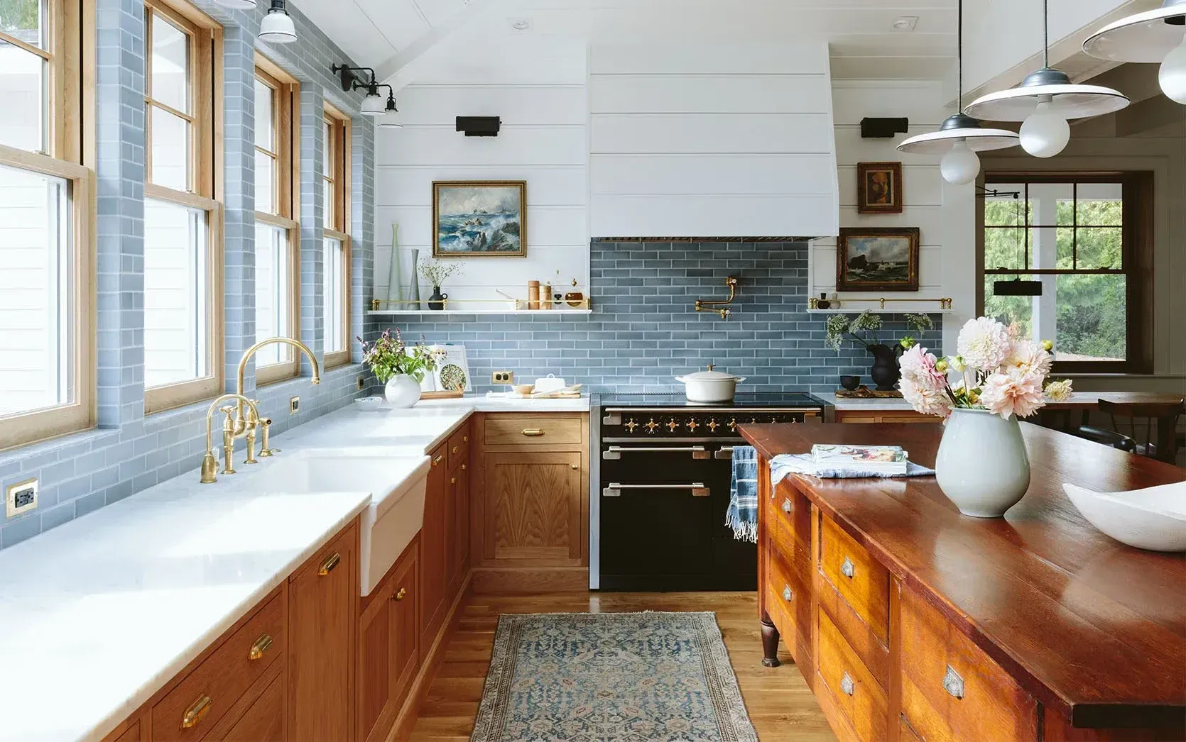 A kitchen with wooden cabinets , a black stove and a sink.