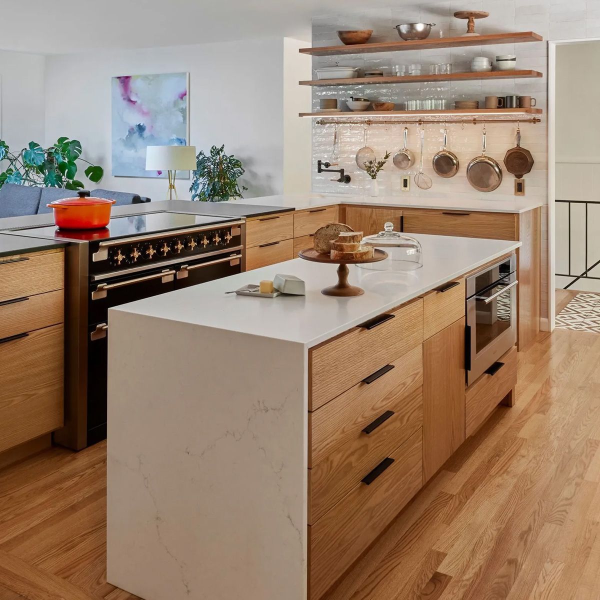 In this 1961 kitchen remodel the client requested an island even though space was tight. Arciform designed an island that is narrower than usual, but large enough to provide tons of extra storage and space for a steam oven. The island is also lower than the surrounding counters to reduce the visual scale and suit the client's height. 