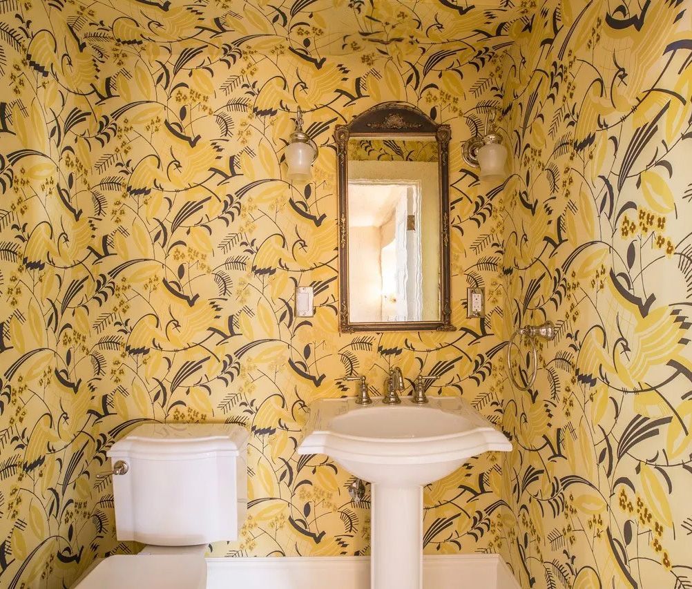 An exuberant Art Deco-inspired paper transforms this petite powder room.