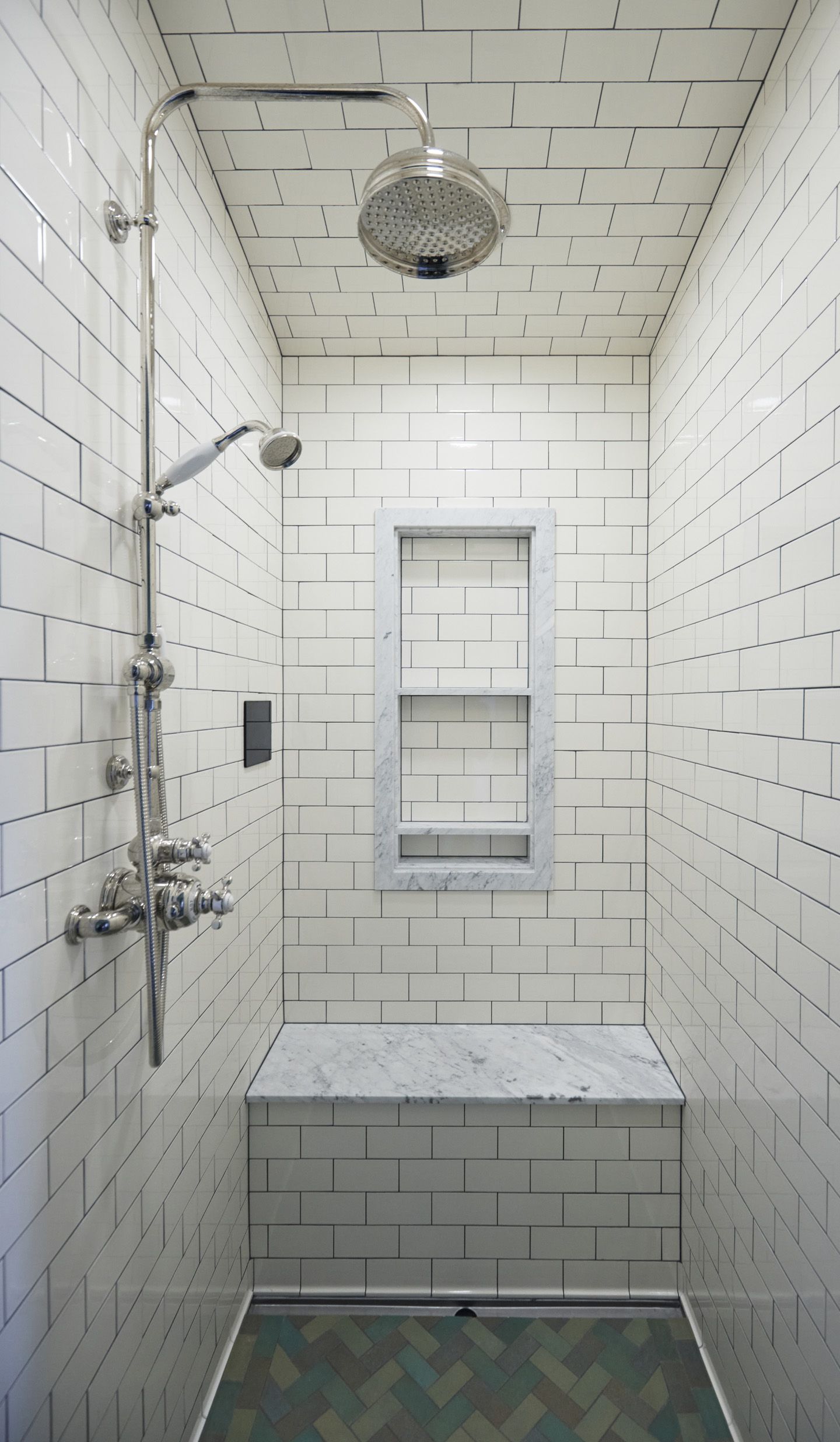 We expanded the guest bath to add a small steam shower with a built in bench, clad in tile and trimmed in marble.