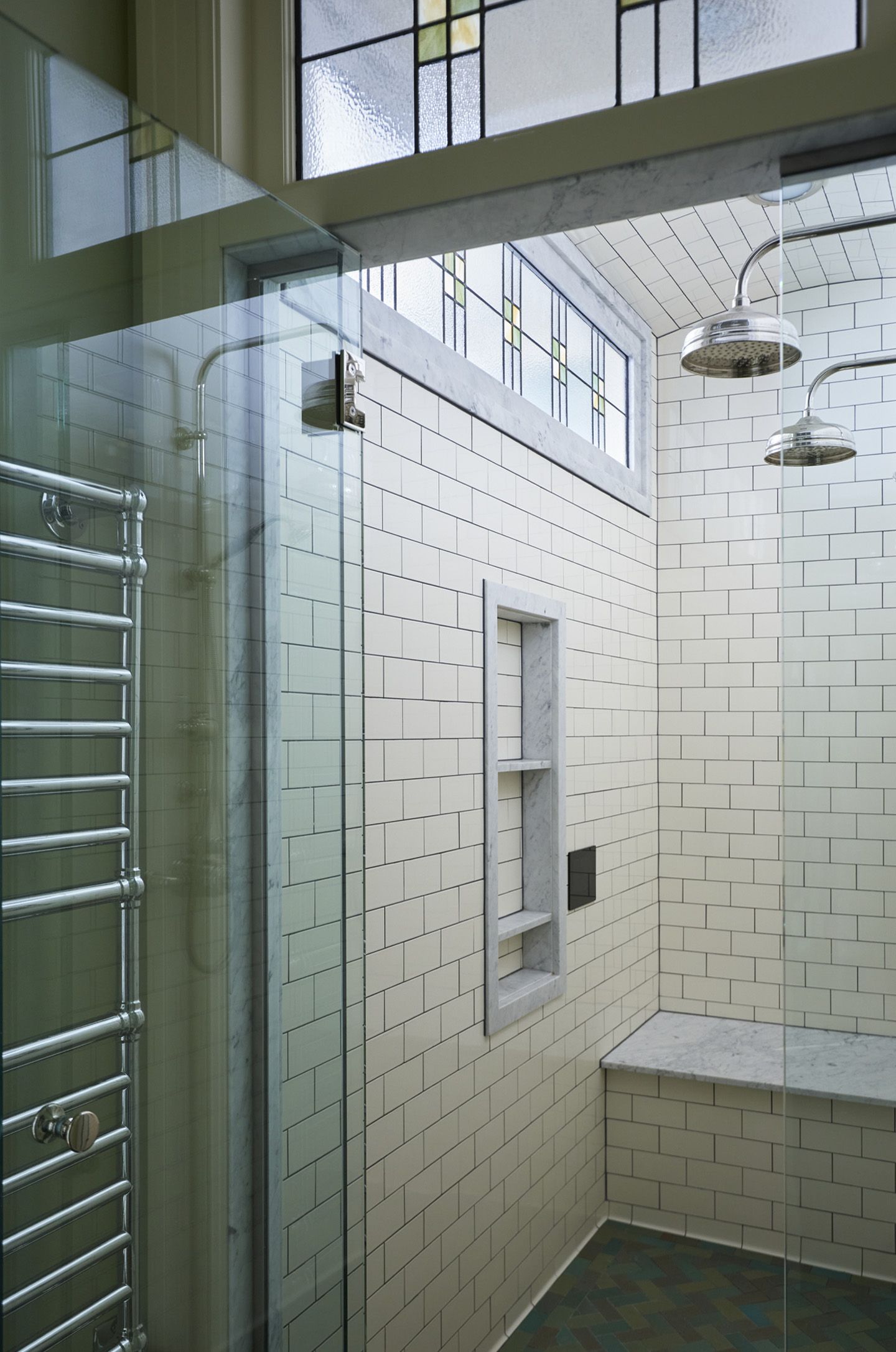 A generous steam shower with windows to the beauty room is fresh and light.