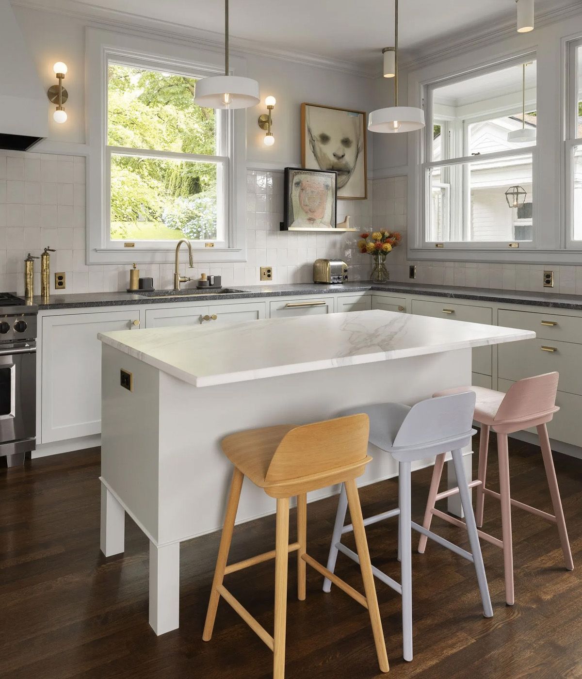 Raised up on square legs, this table sized island has a lighter presence. Banks of drawers facing the sink provide space for utensils while the opposite side has an ample overhang for friends and family to gather. 