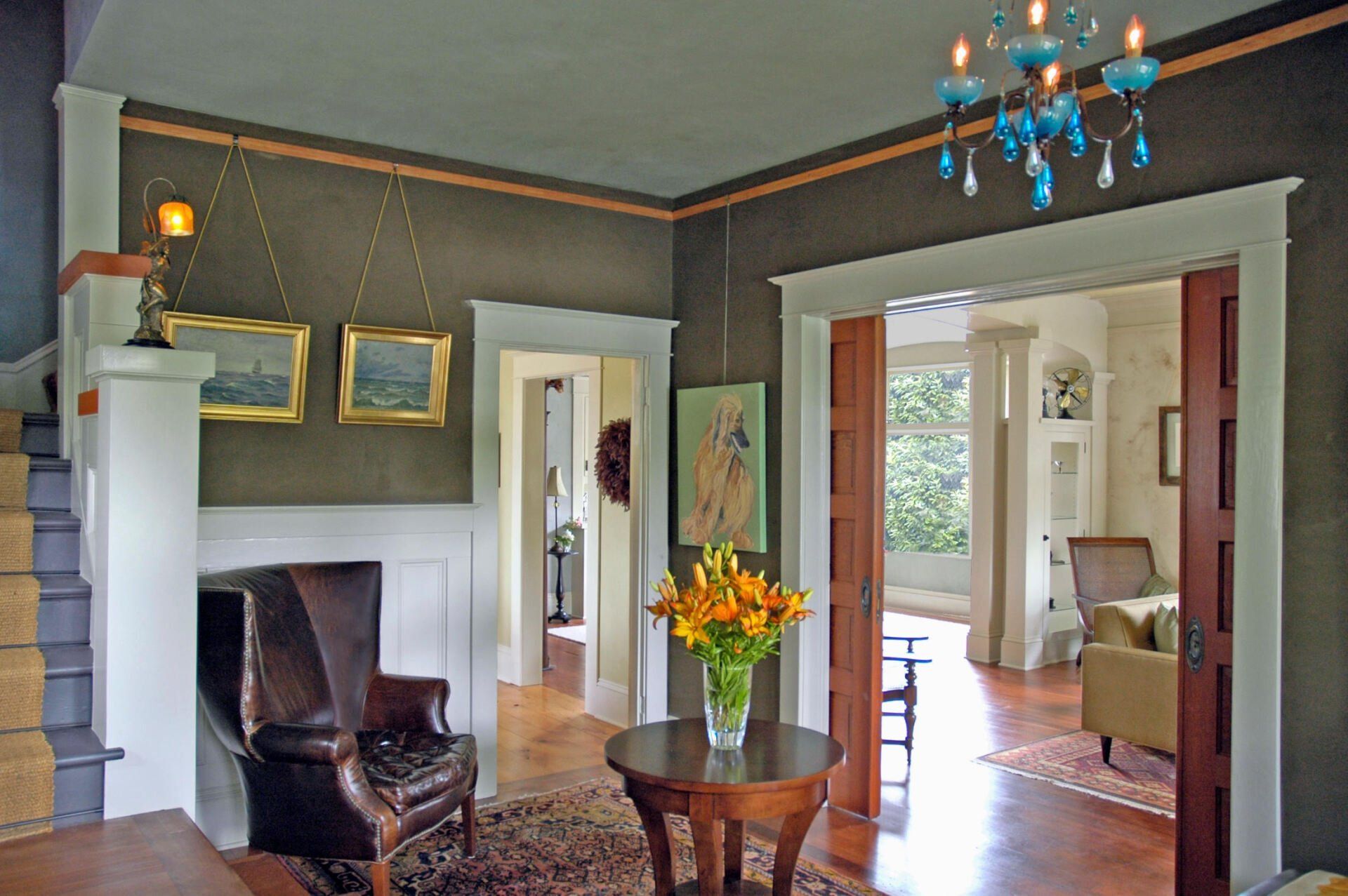 Inside the front door, the entryway has stairs on the left, a cased opening to the living room on the right and a doorway to the kitchen between.