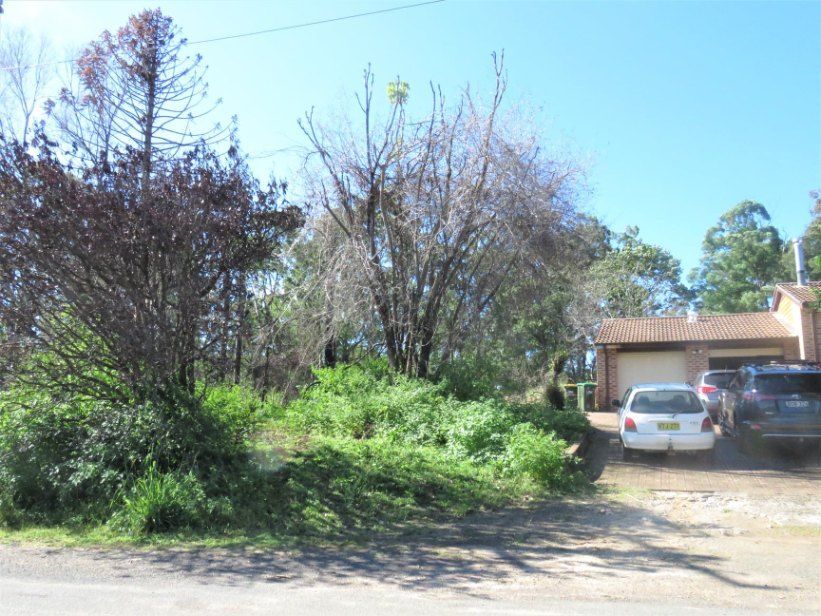 A White Car is Parked in Front of a House — Jeff Pearce Tree Services in Wauchope, NSW