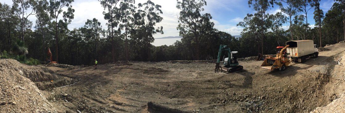 A Large Pile of Dirt is Sitting in the Middle of a Dirt Field — Jeff Pearce Tree Services in Wingham, NSW