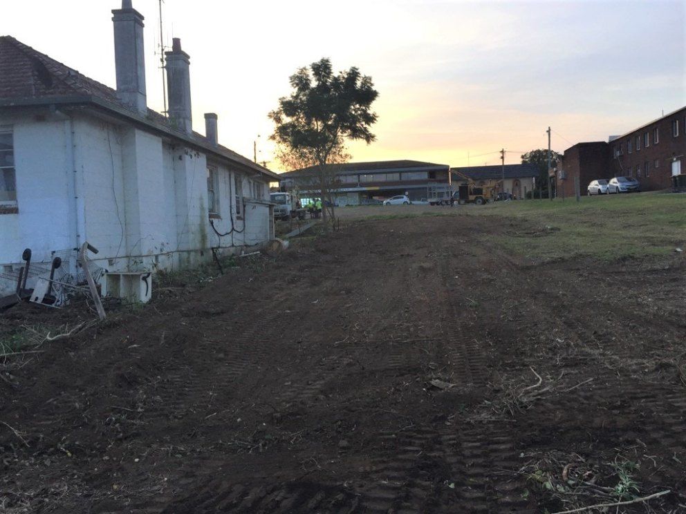 A Dirt Road With a House in the Background — Jeff Pearce Tree Services in Forster, NSW