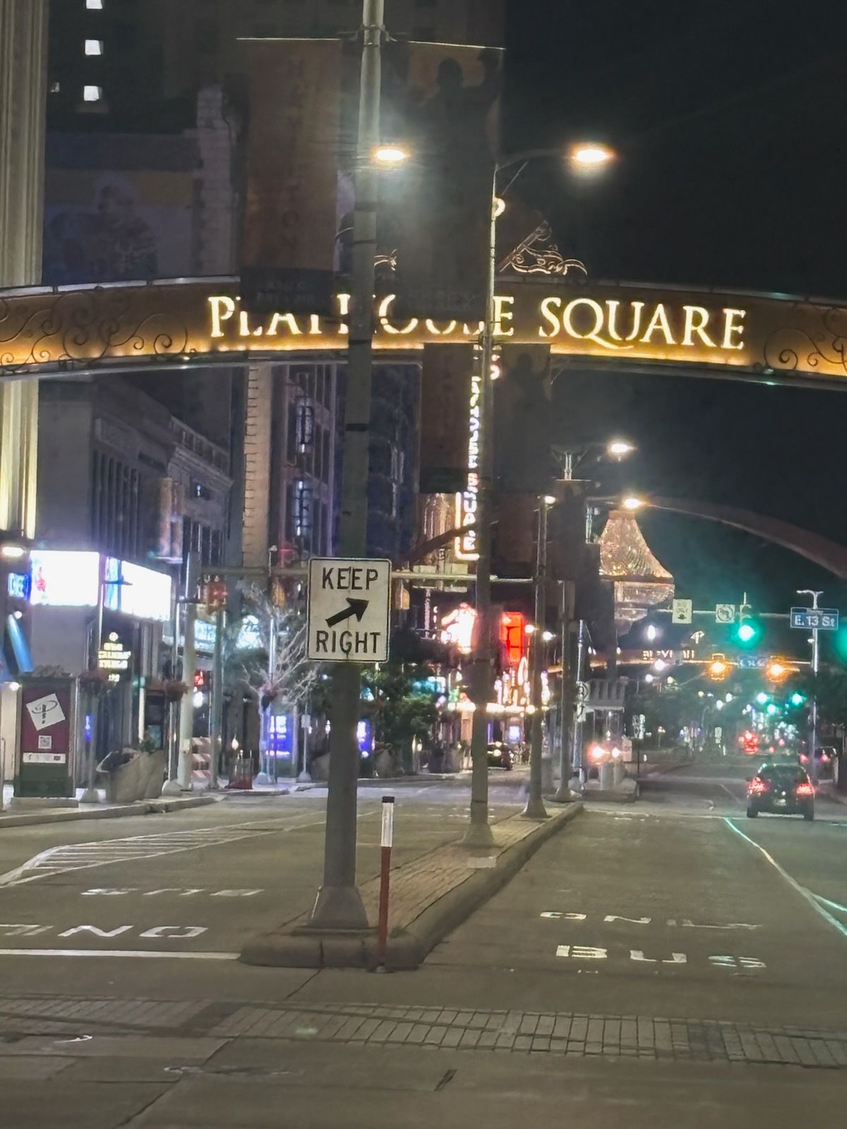 An empty street with a sign that says