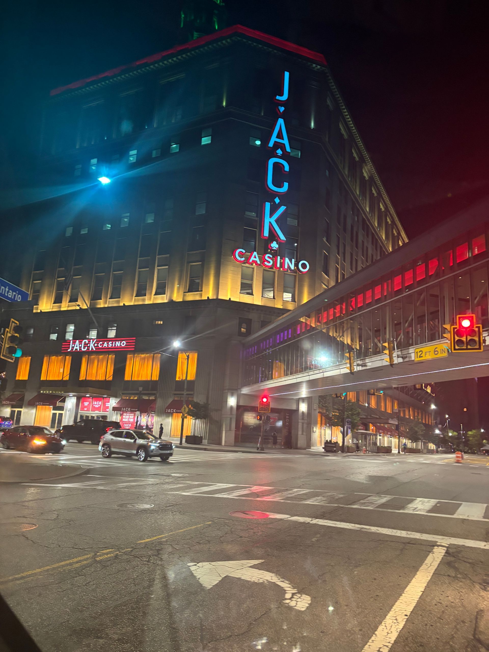 A large building with the word jack on it is lit up at night