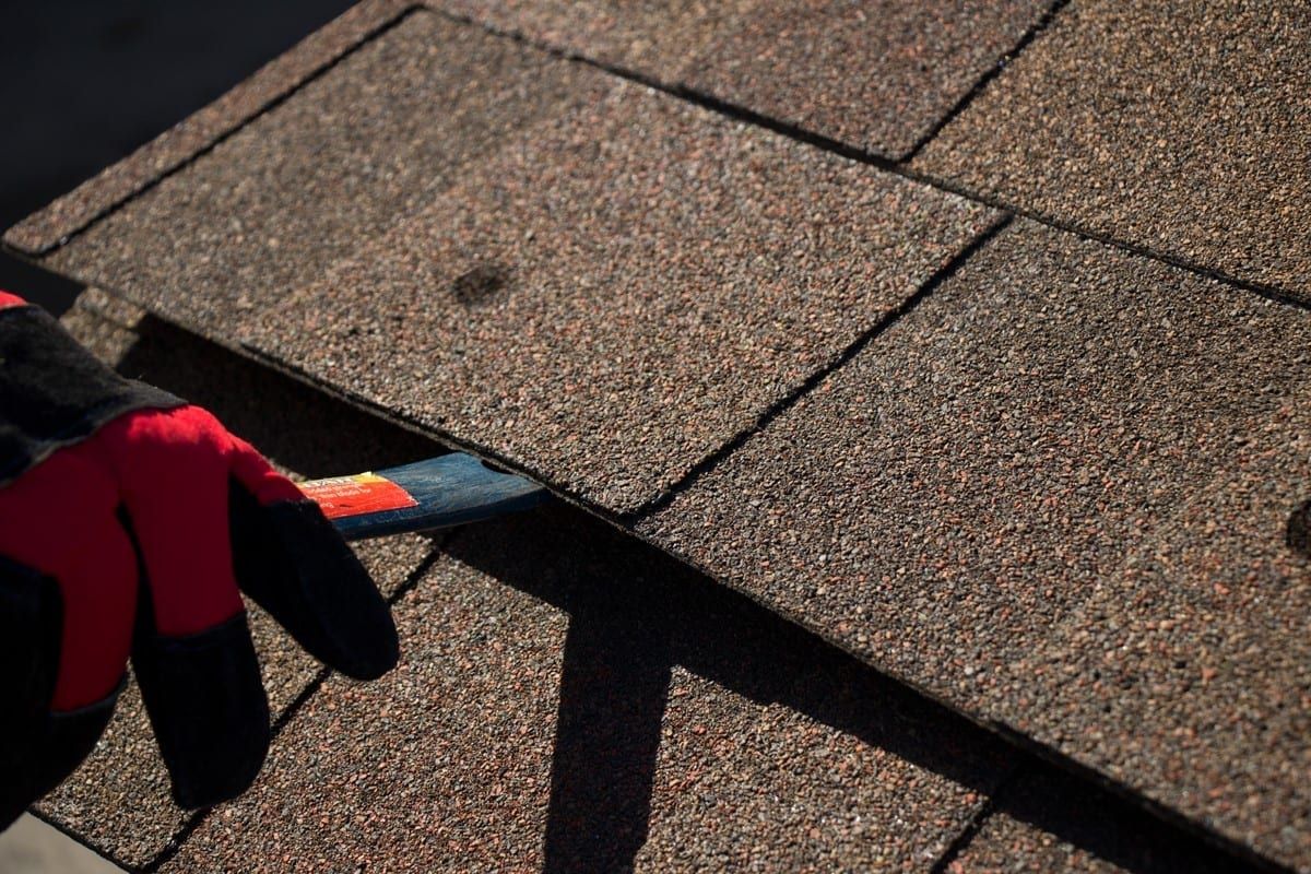 A man is working on the roof of a building.