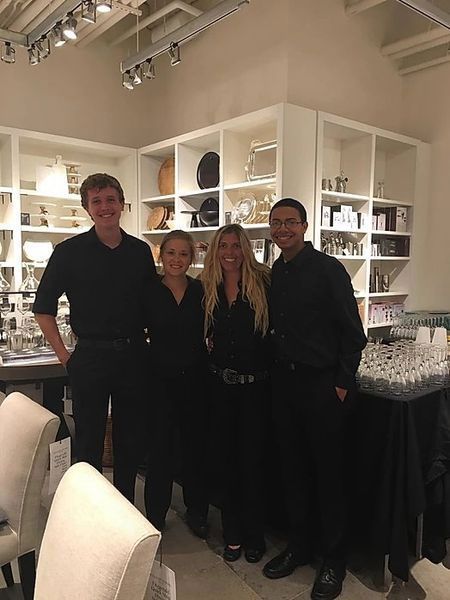 A group of people standing next to each other in a room.