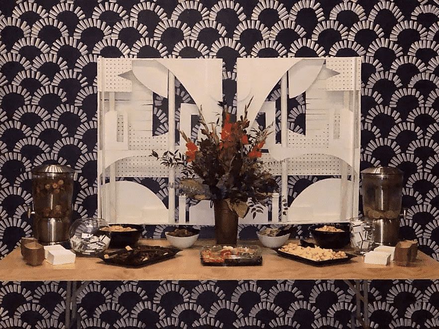 A table with a vase of flowers and bowls on it