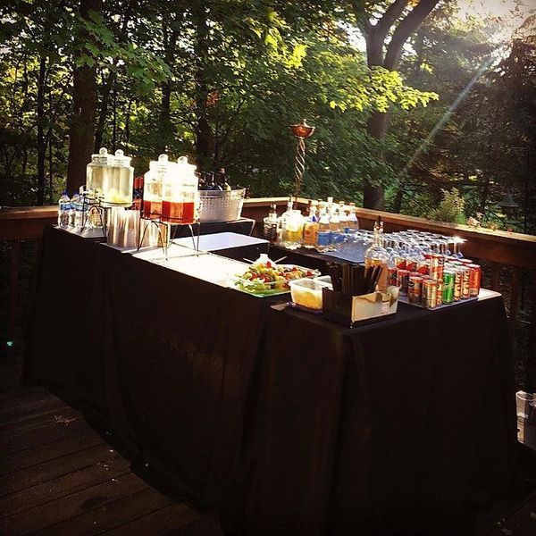 A table with lots of drinks and food on it