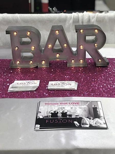 A table with a sign that says bar on it
