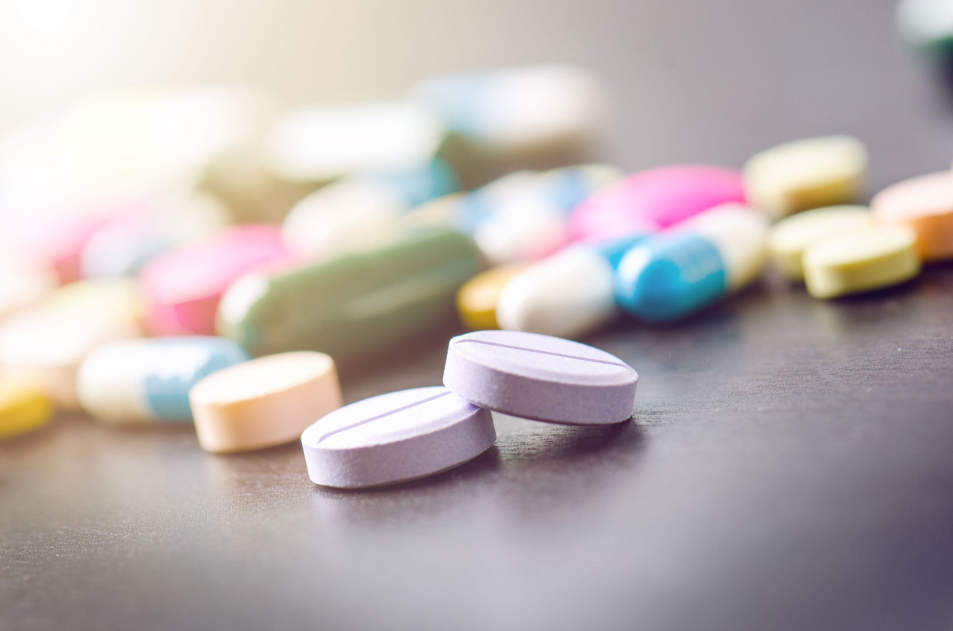 There are many different types of pills on the table.