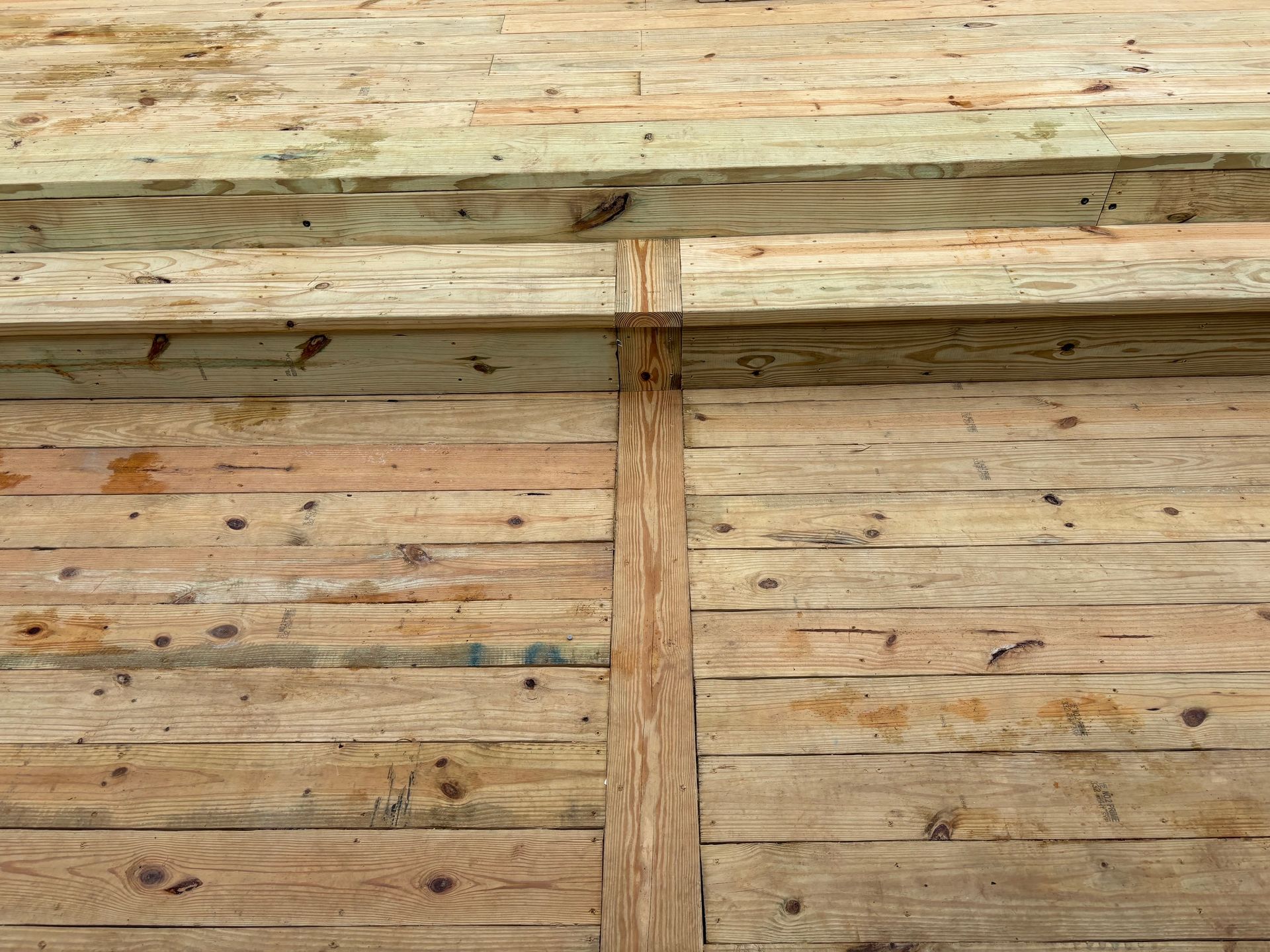 A close up of a wooden wall with a few pieces of wood on it.