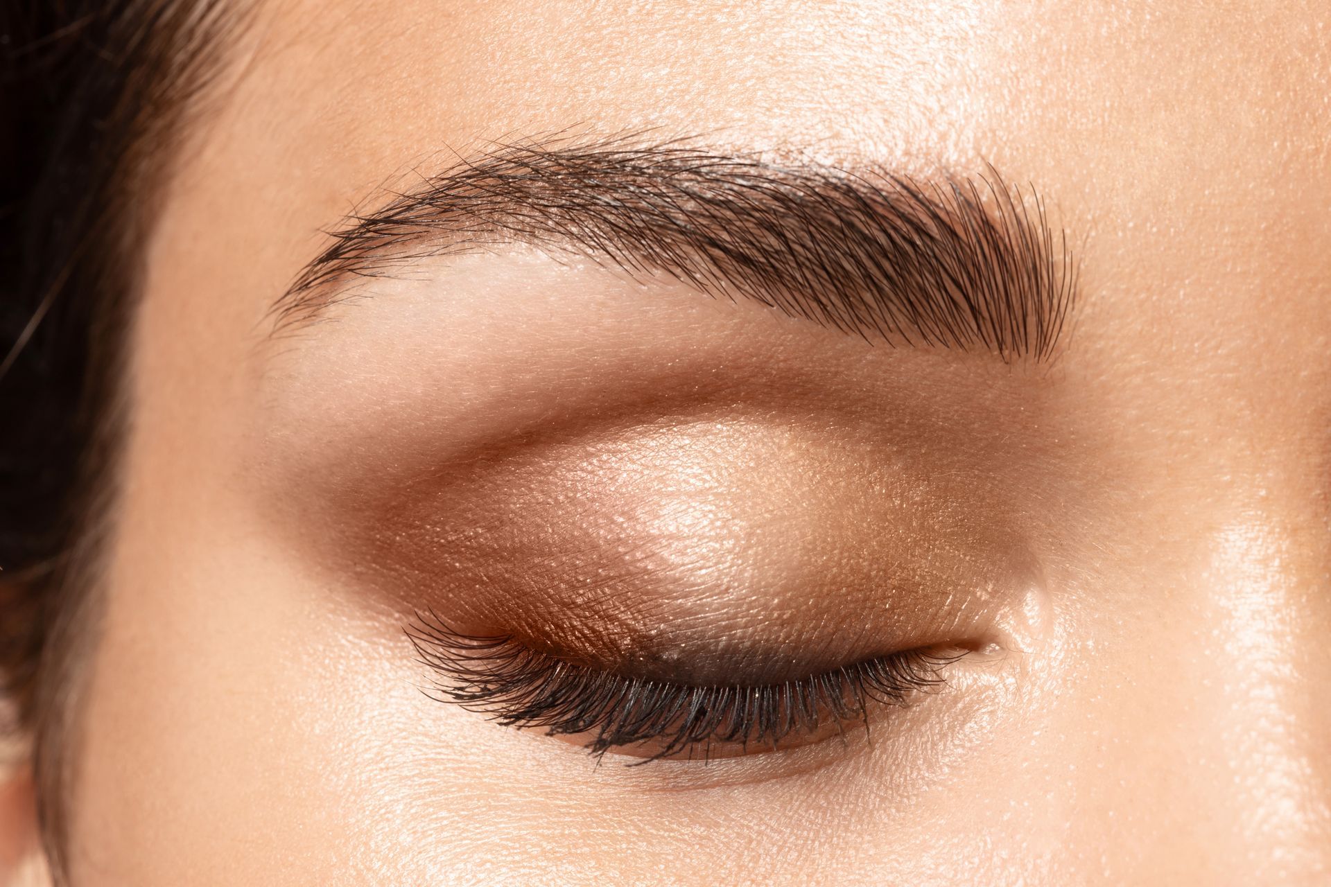 A close up of a woman 's eye with makeup on.
