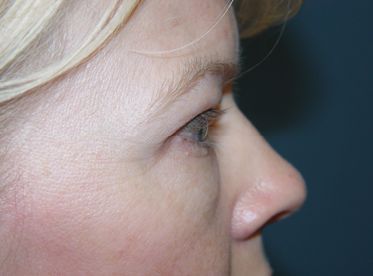 A close up of a woman 's face with her eyes closed.