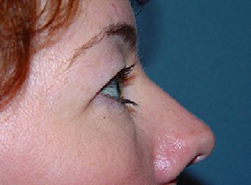A close up of a woman 's face with her eyes closed.