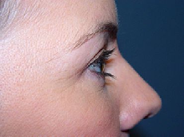 A close up of a woman 's eye and nose.