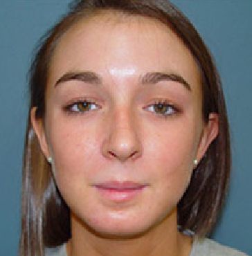 A close up of a woman 's face with a blue background.