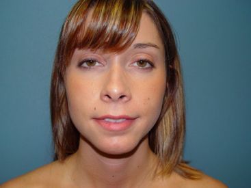A close up of a woman 's face with a blue background.