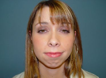 A close up of a woman 's face with her eyes closed.