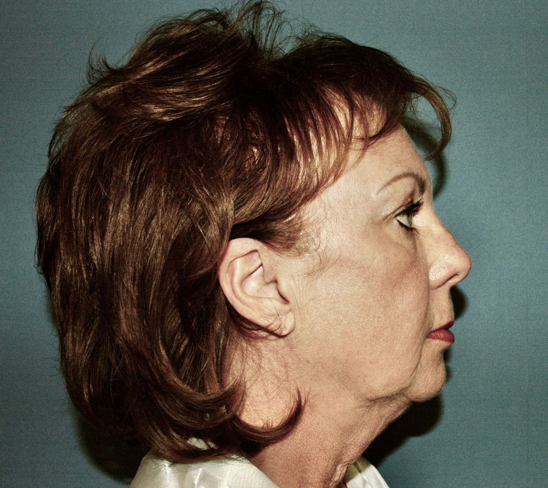 A close up of a woman 's face with a blue background