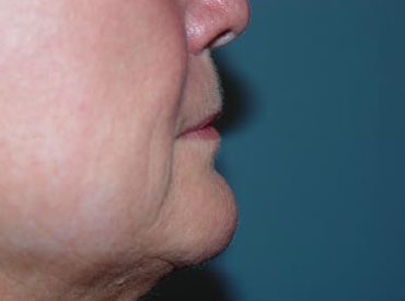 A close up of a woman 's face with a blue background.