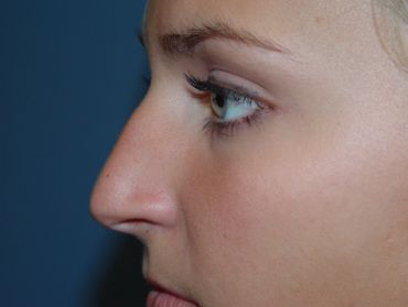 A close up of a woman 's nose and eye.