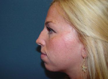 A close up of a woman 's face with blonde hair and earrings.