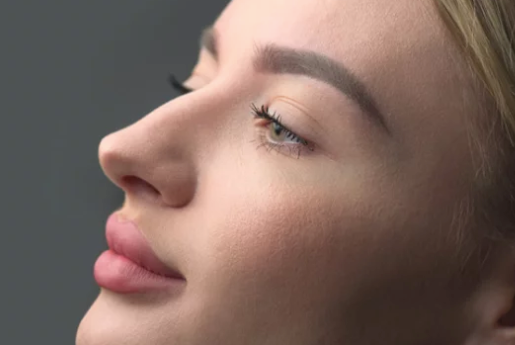 A close up of a woman 's face with her eyes closed.