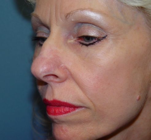 A close up of a woman 's face with red lipstick.