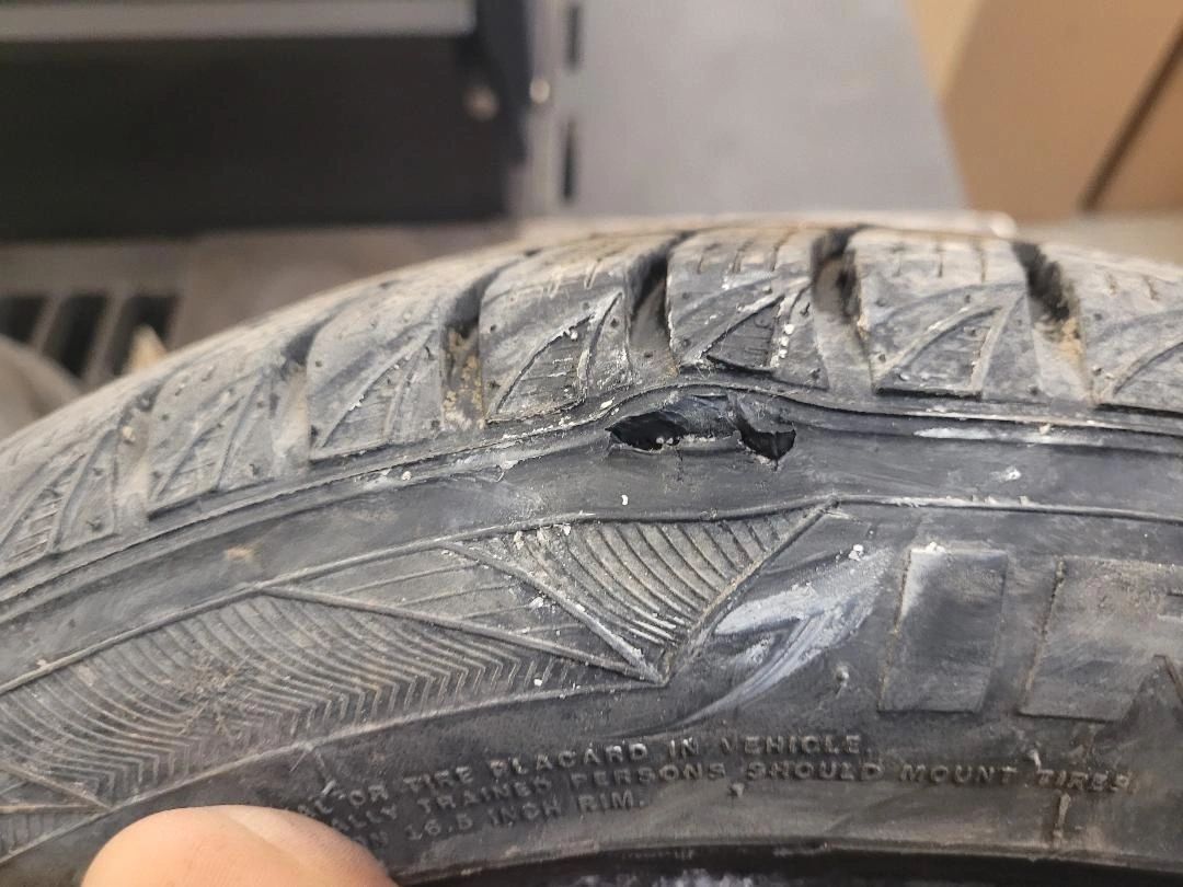 Damaged car tire with a visible hole in the sidewall | Highlift Auto Service