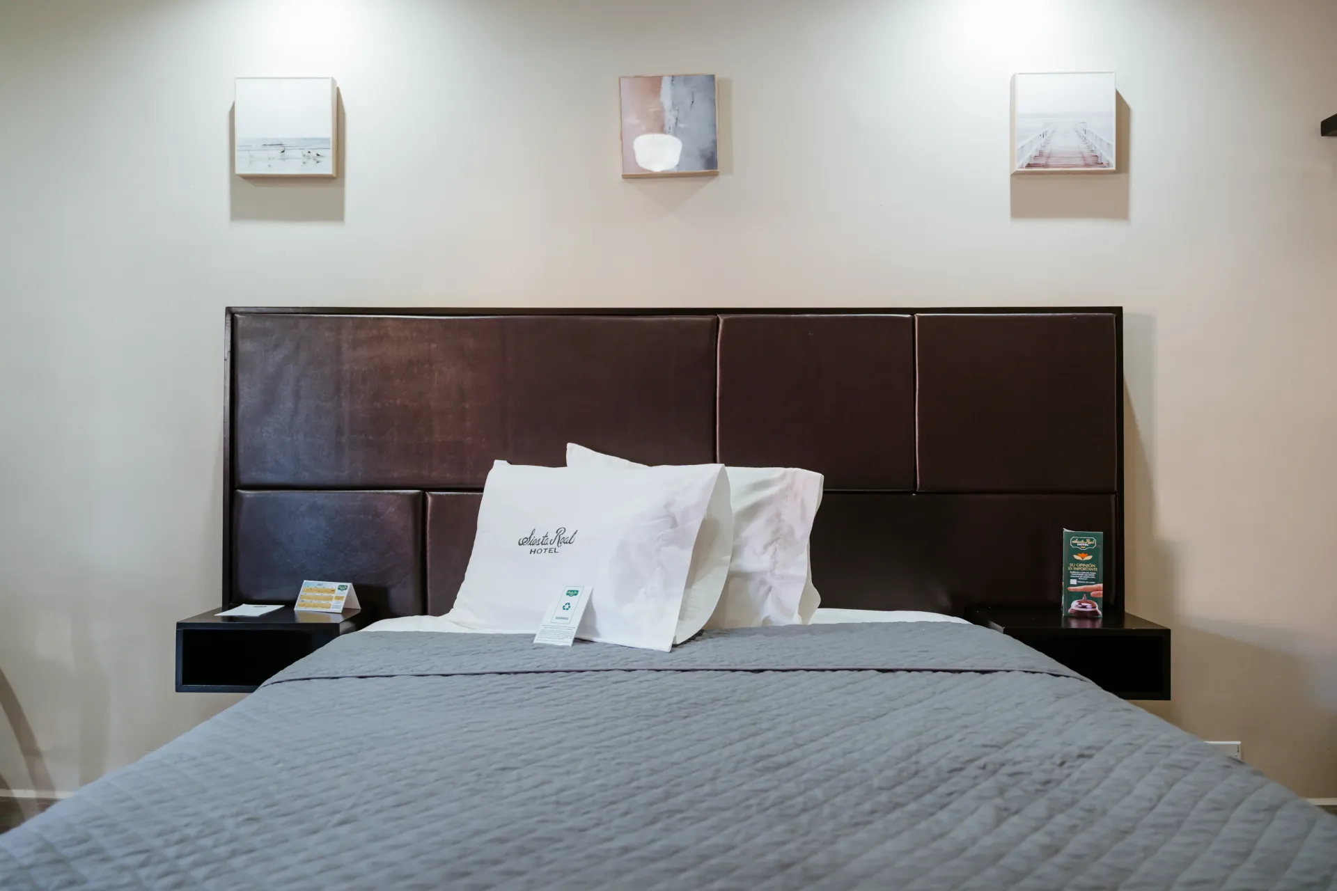 A hotel room with a bed and a headboard